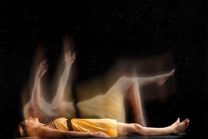 a woman in a yellow dress appears to leaving her own body