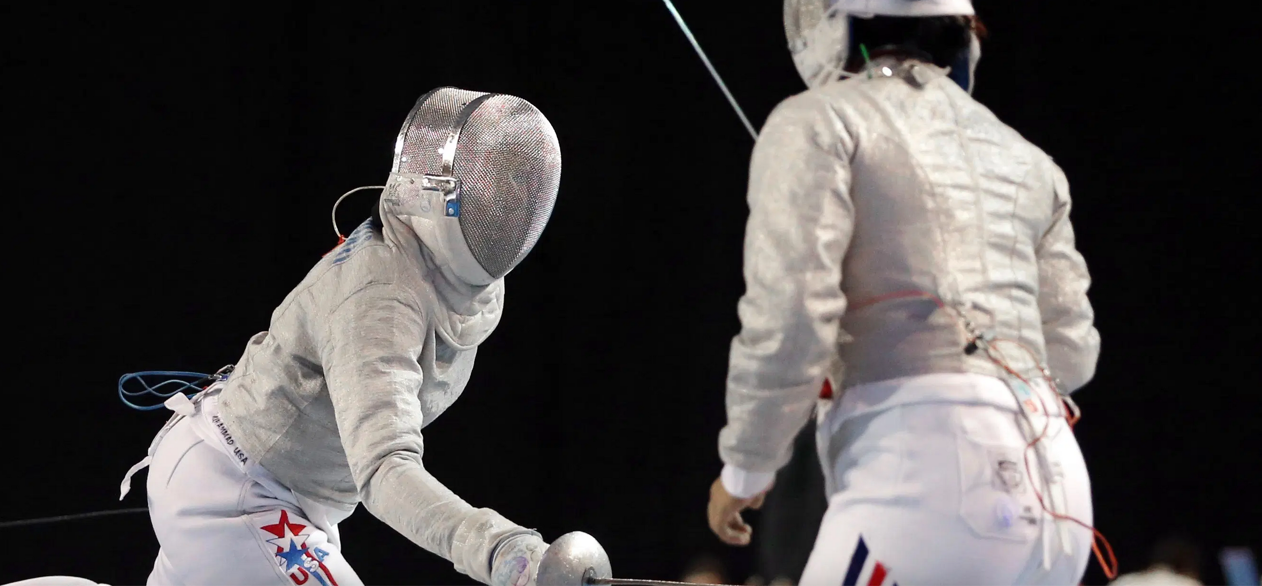 two fencers face off