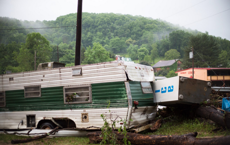 a battered trailer with debris around it