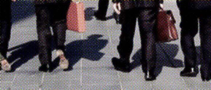 back leg shot of people wearing suits and holding briefcases