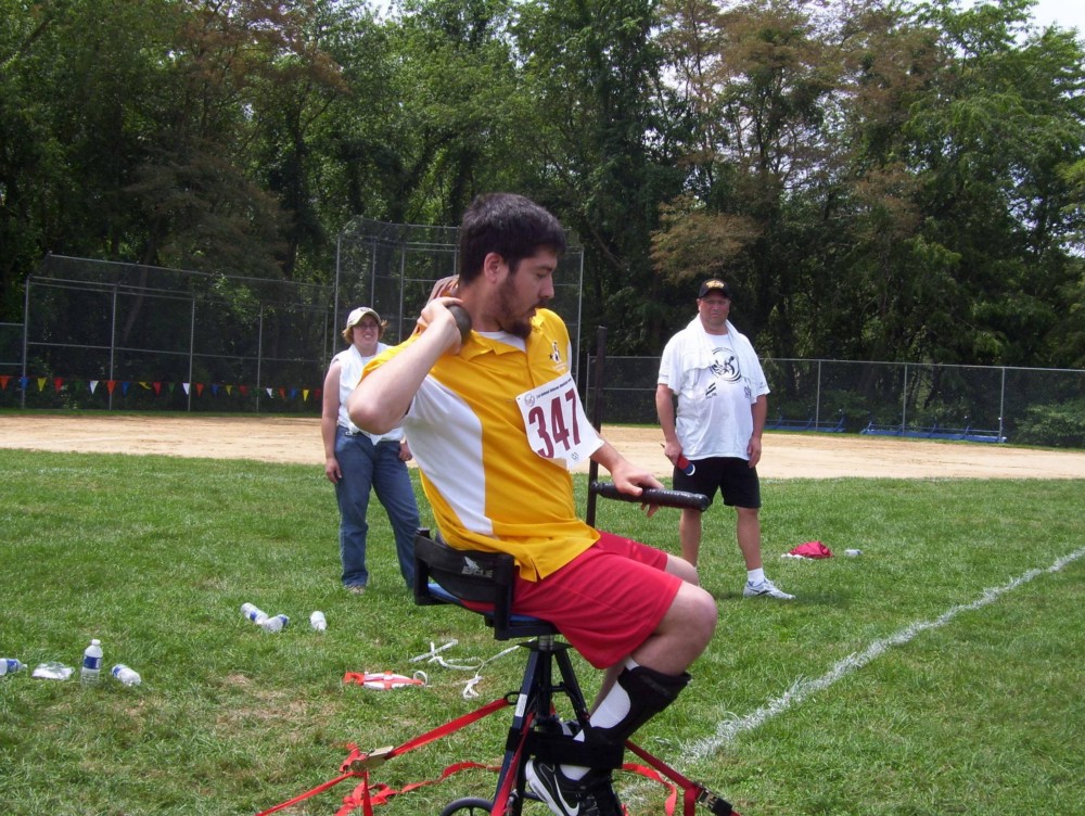 spectators watching a man prepare to throw a shot put