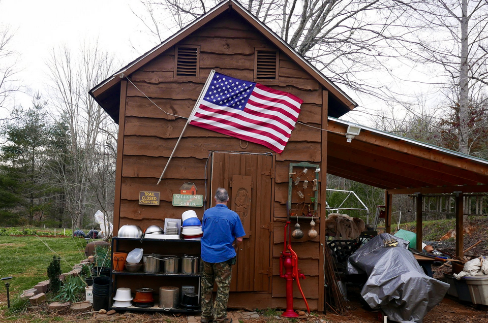 small cabin with a large American flag on it