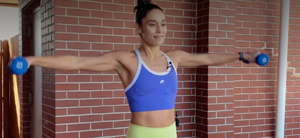 person raising arms out until they’re parallel to the floor at shoulder heigh