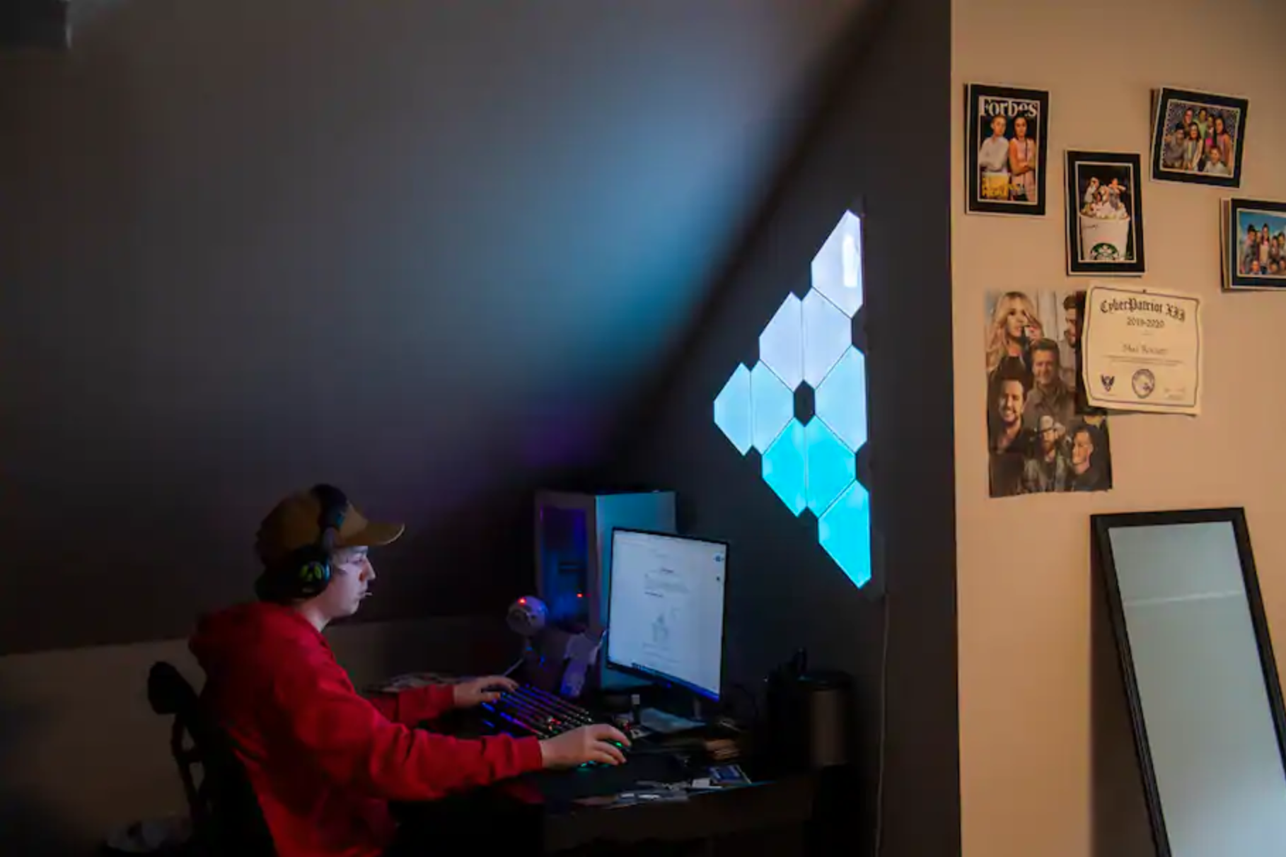 a young person at home on a computer with headphones on