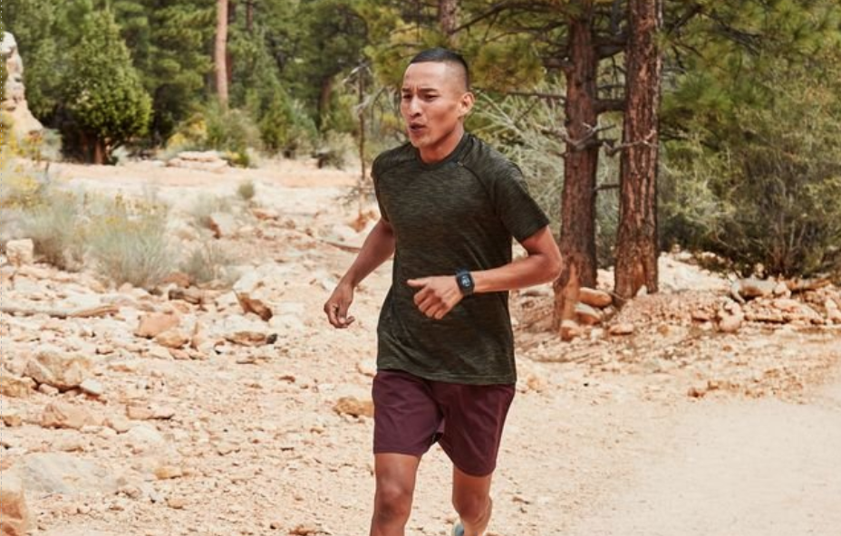 a person running on a trail in a forested area