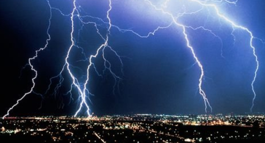 lightning strikes above a city skyline