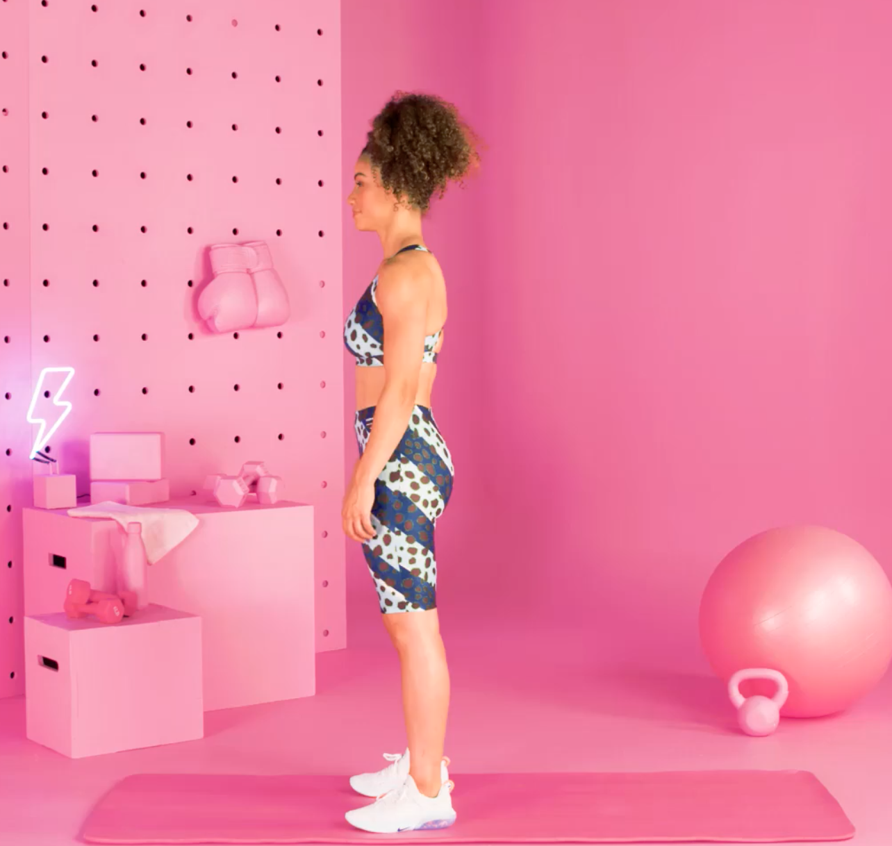 a person doing burpees in a pink room