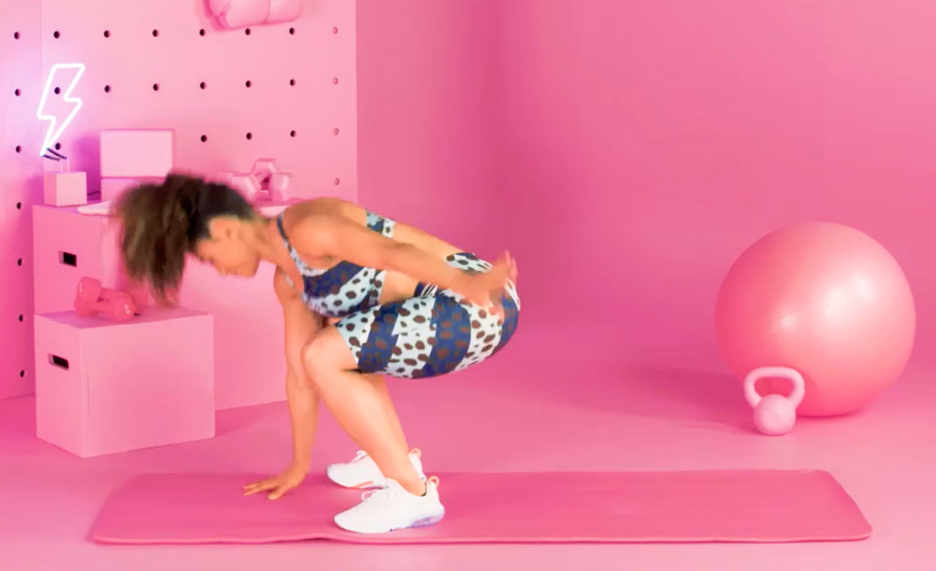 a person doing burpees in a pink room