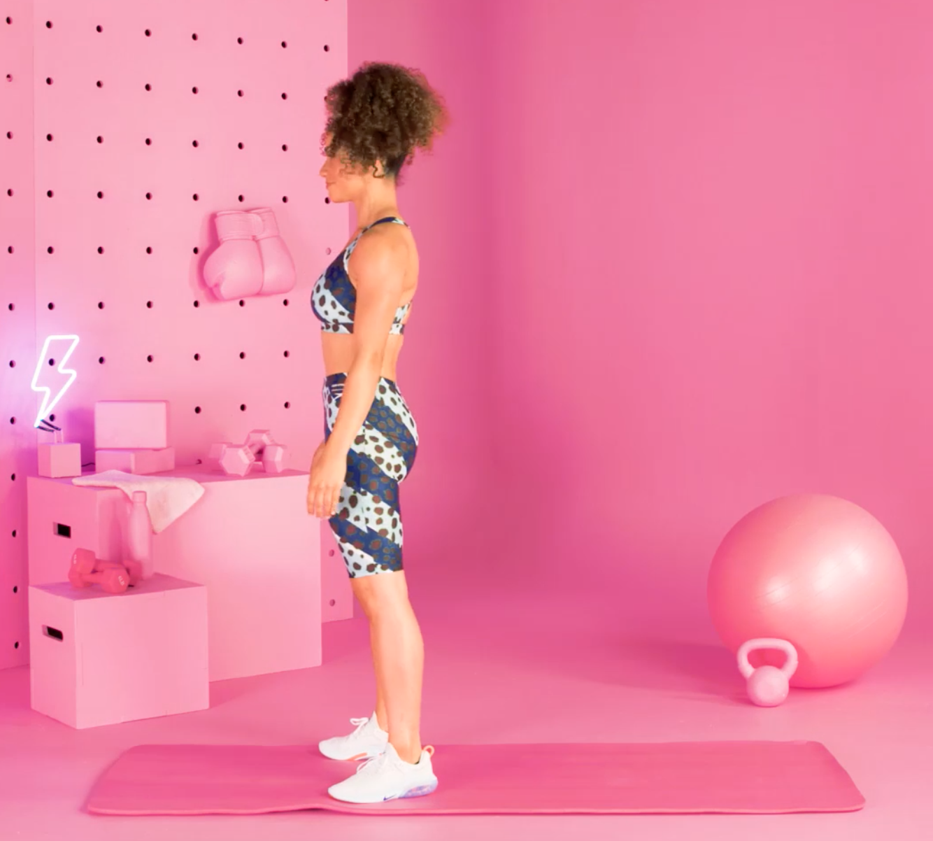 a person doing burpees in a pink room