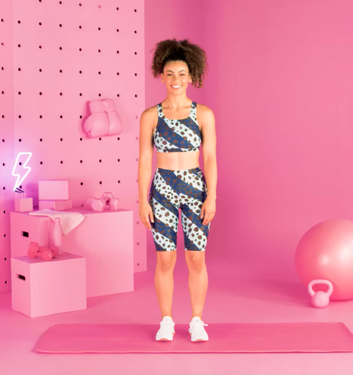 a person doing burpees in a pink room