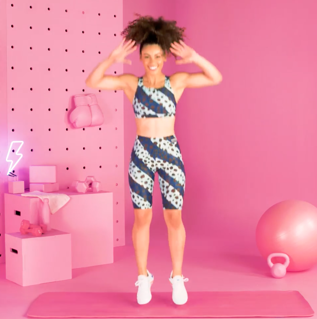 a person doing burpees in a pink room