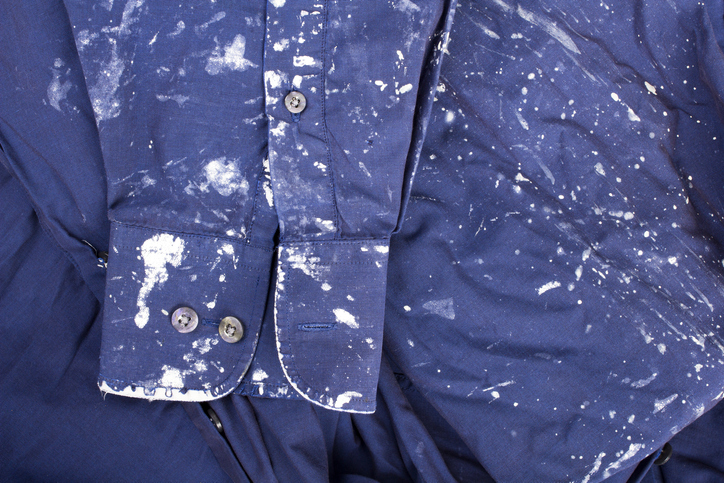 a blue shirt stained with white paint