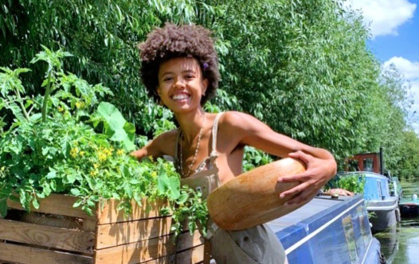 smiling woman harvesting veggies