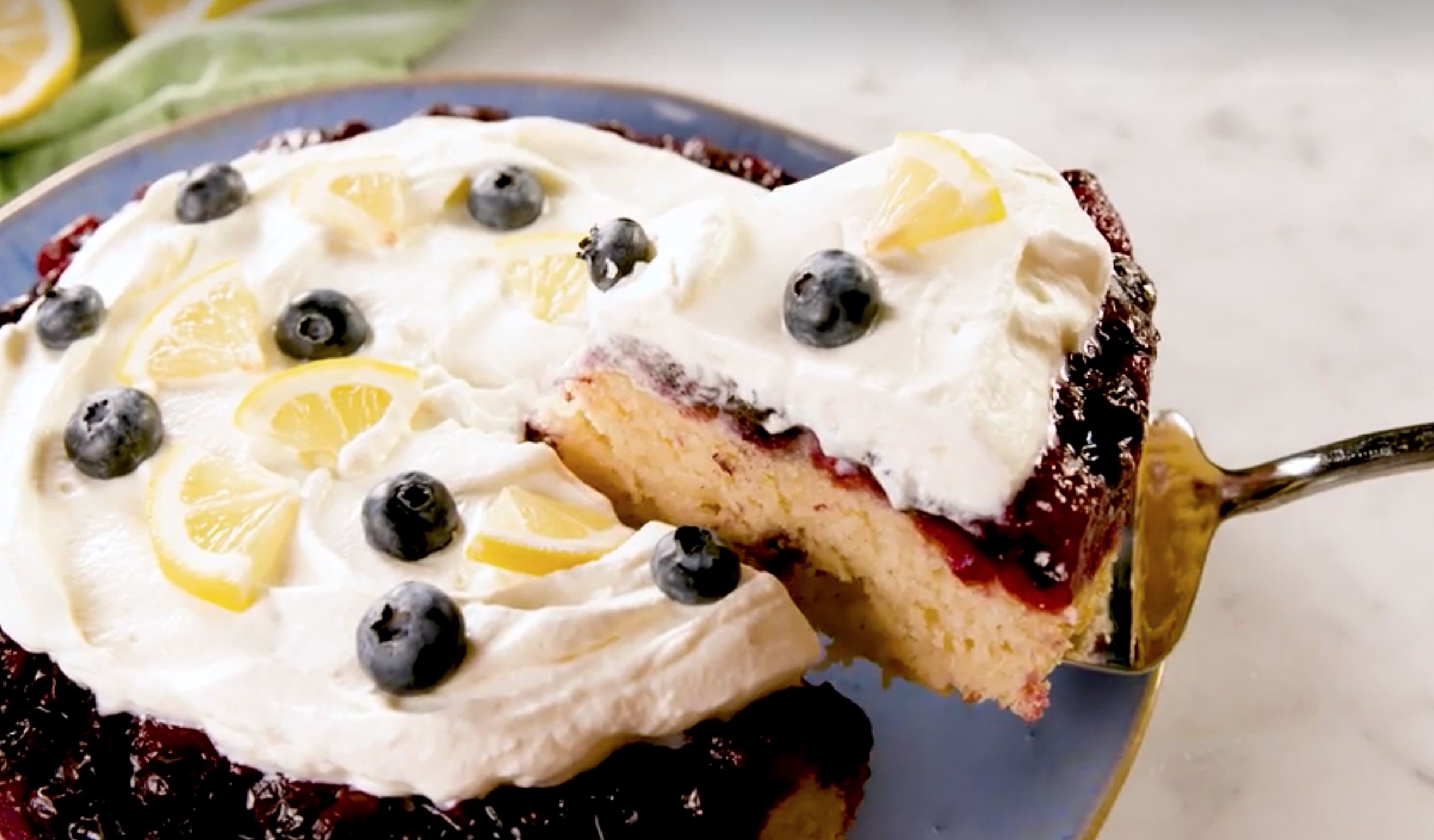 cake with lemon and blueberries and white frosting