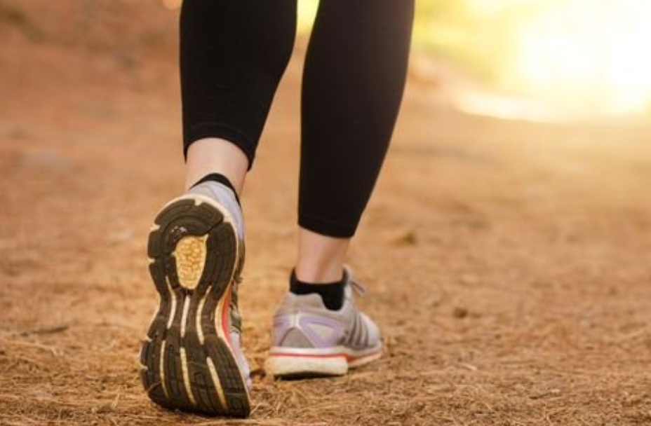 someone in work-out gear walking on a path