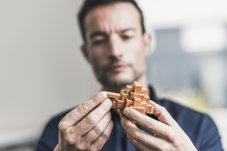 person putting together a puzzle