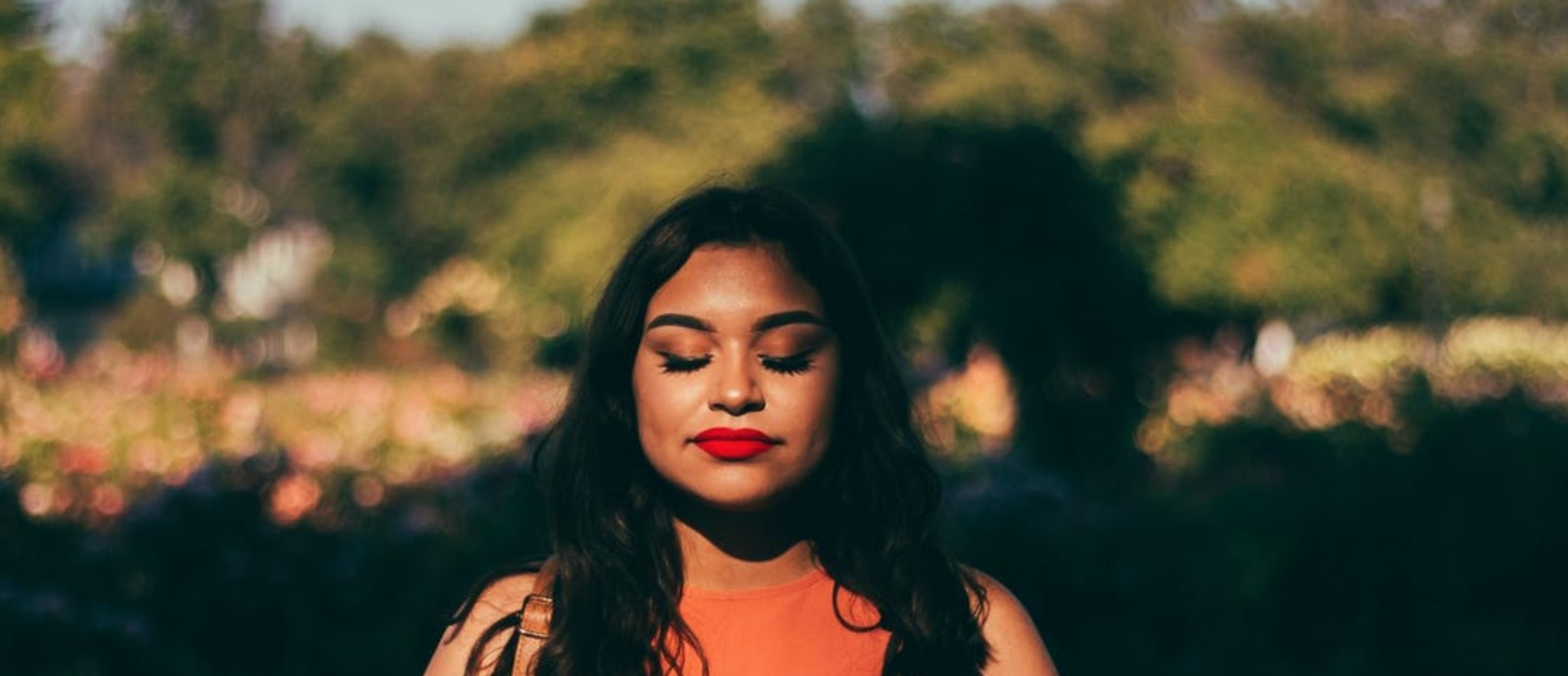 woman with eyes closed, seemingly at peace