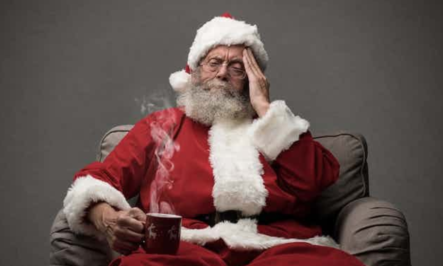 a tired-looking santa with a mug