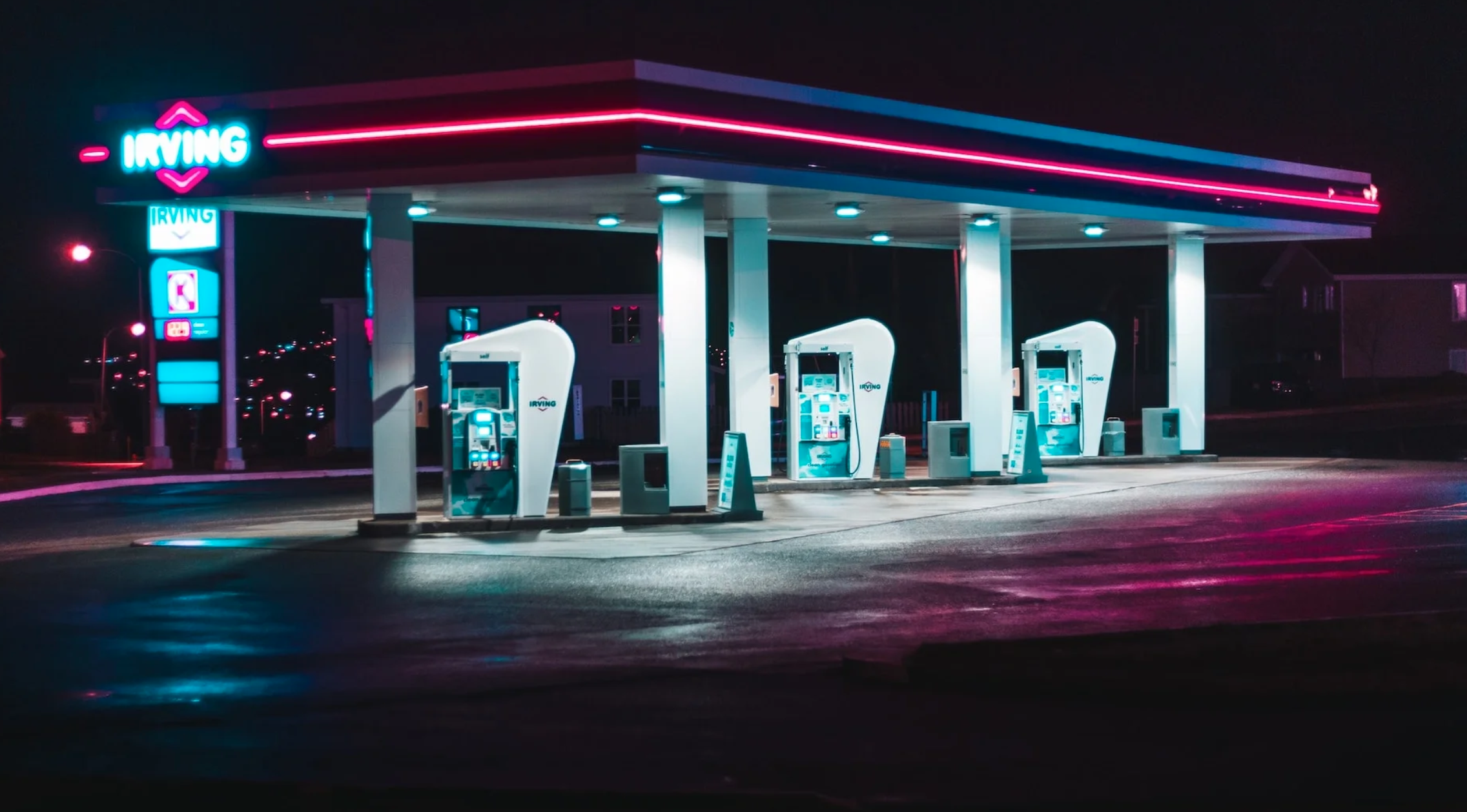 an emtpy, retro-looking gas station at night