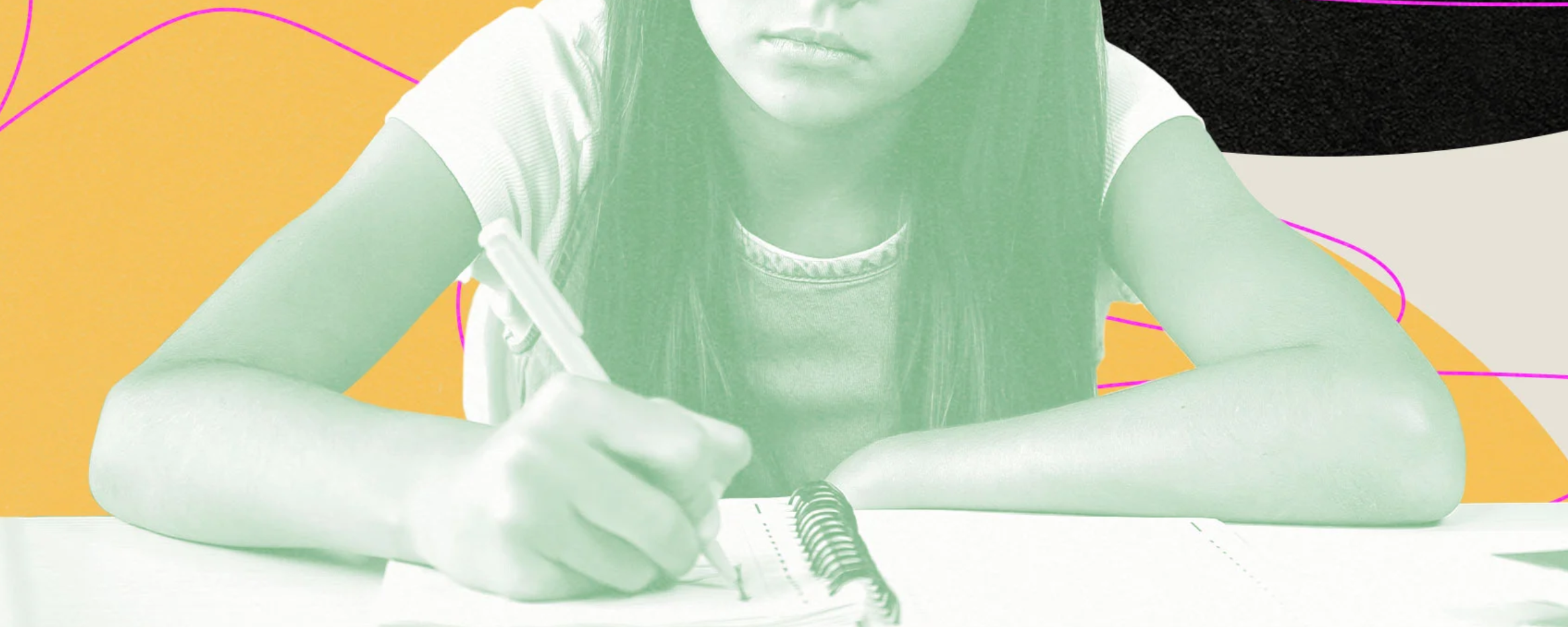 a young child holding a pen to paper