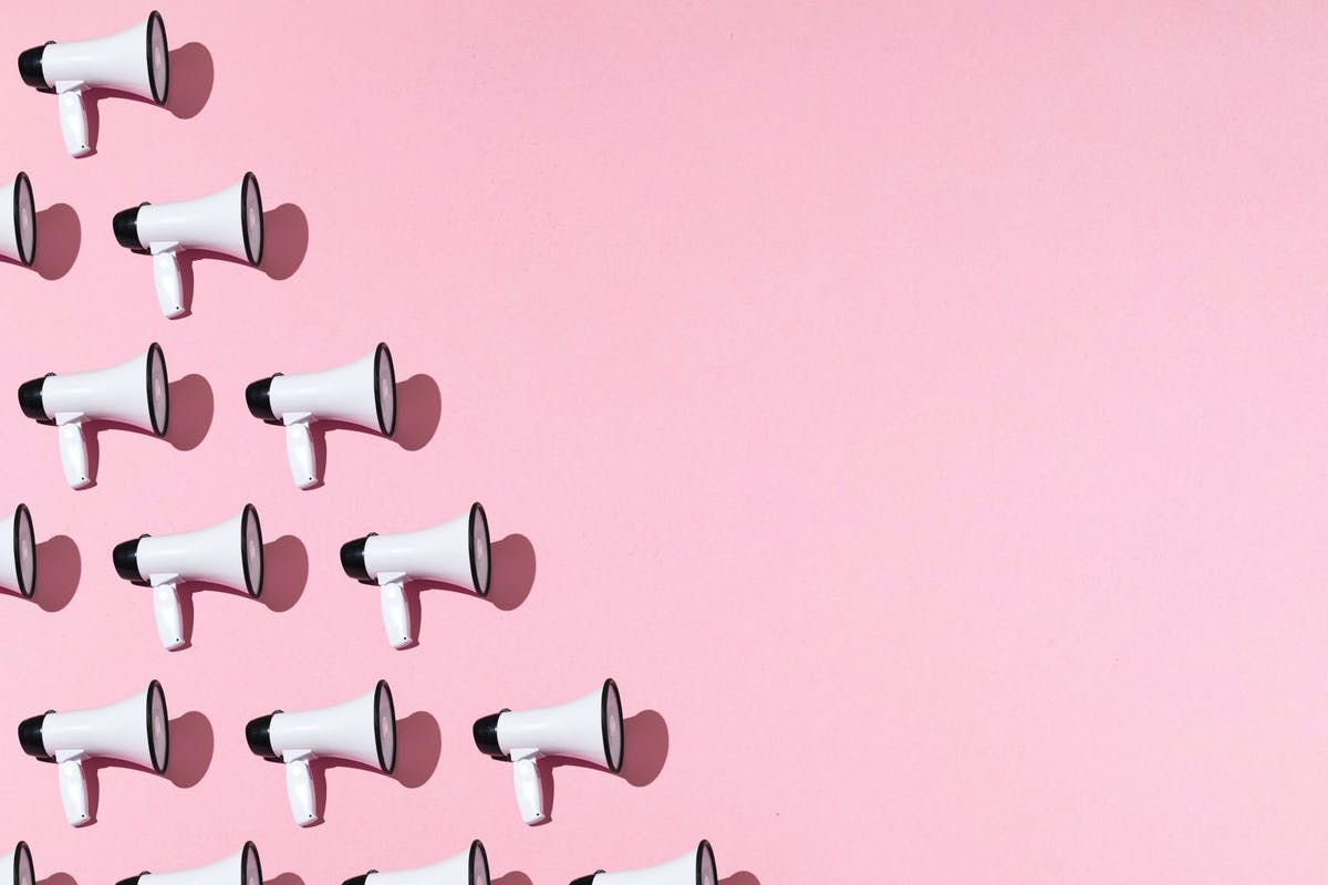 megaphones against a pink backdrop