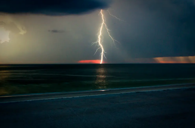 a bolt of lightning against a stormy sea sky