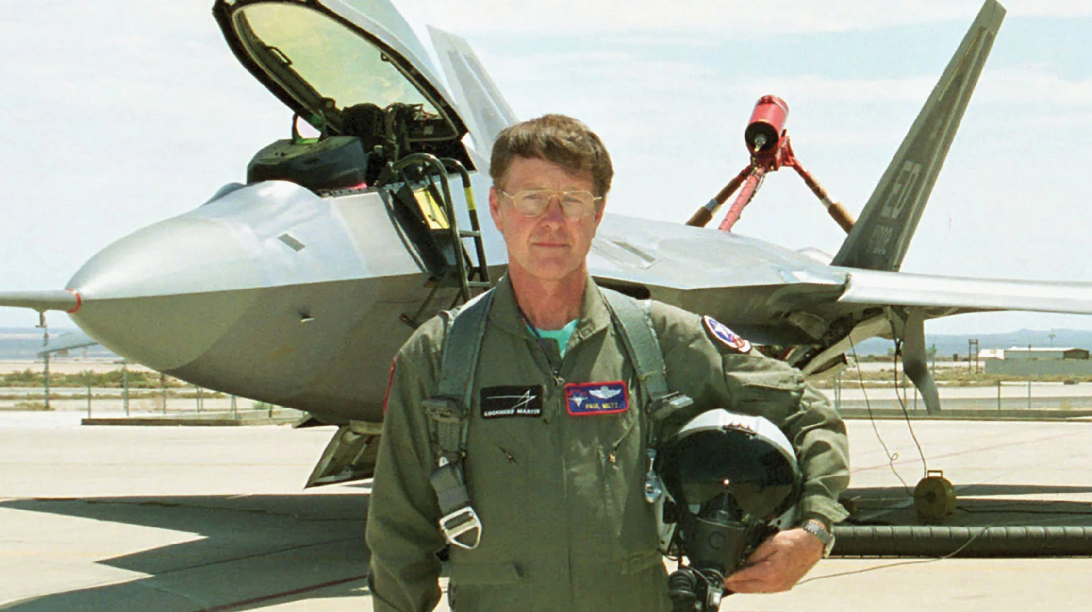 pilot standing in front of a jet