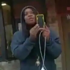 Screencap of Darnella Frazier filming with phone