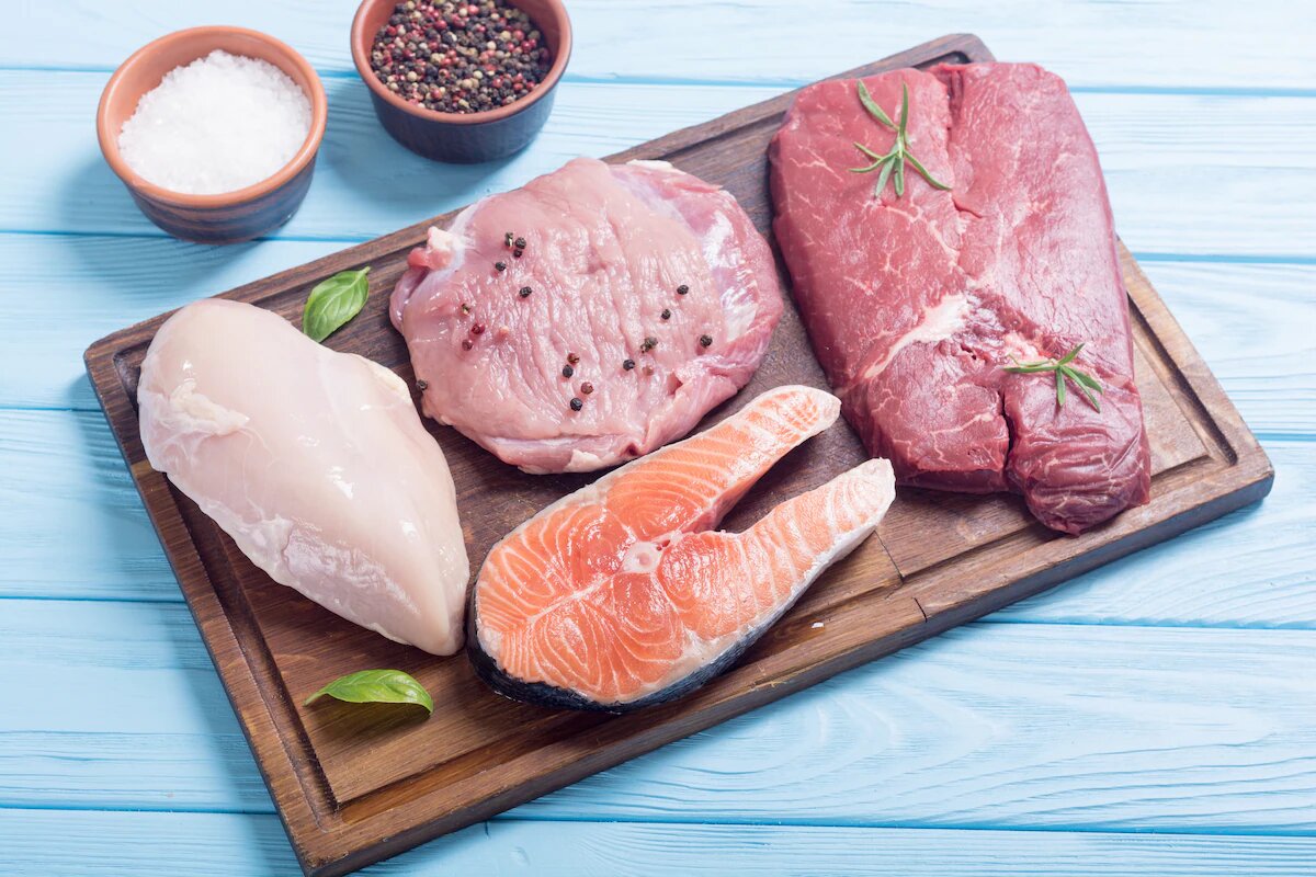 Different types of raw meat on a cutting board