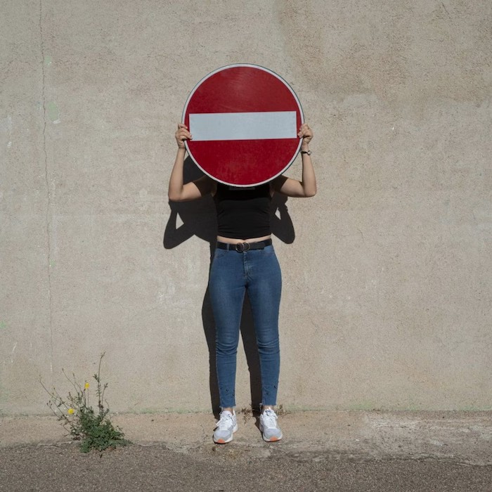 woman holding road sign
